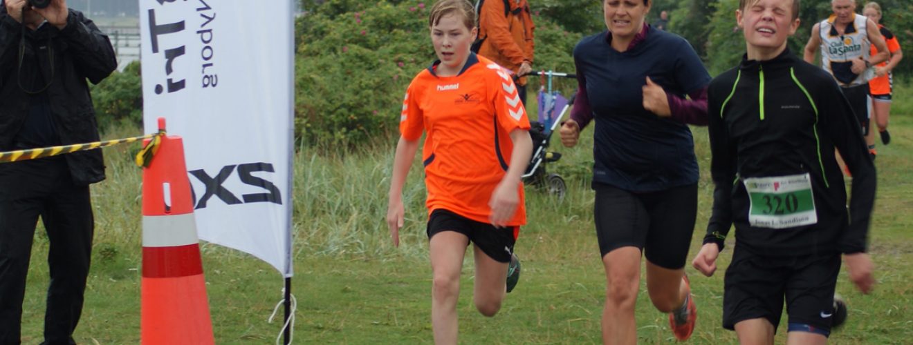 3 løbere på målstregen med fotograf i baggrunden til NyborgTri 4-18-4